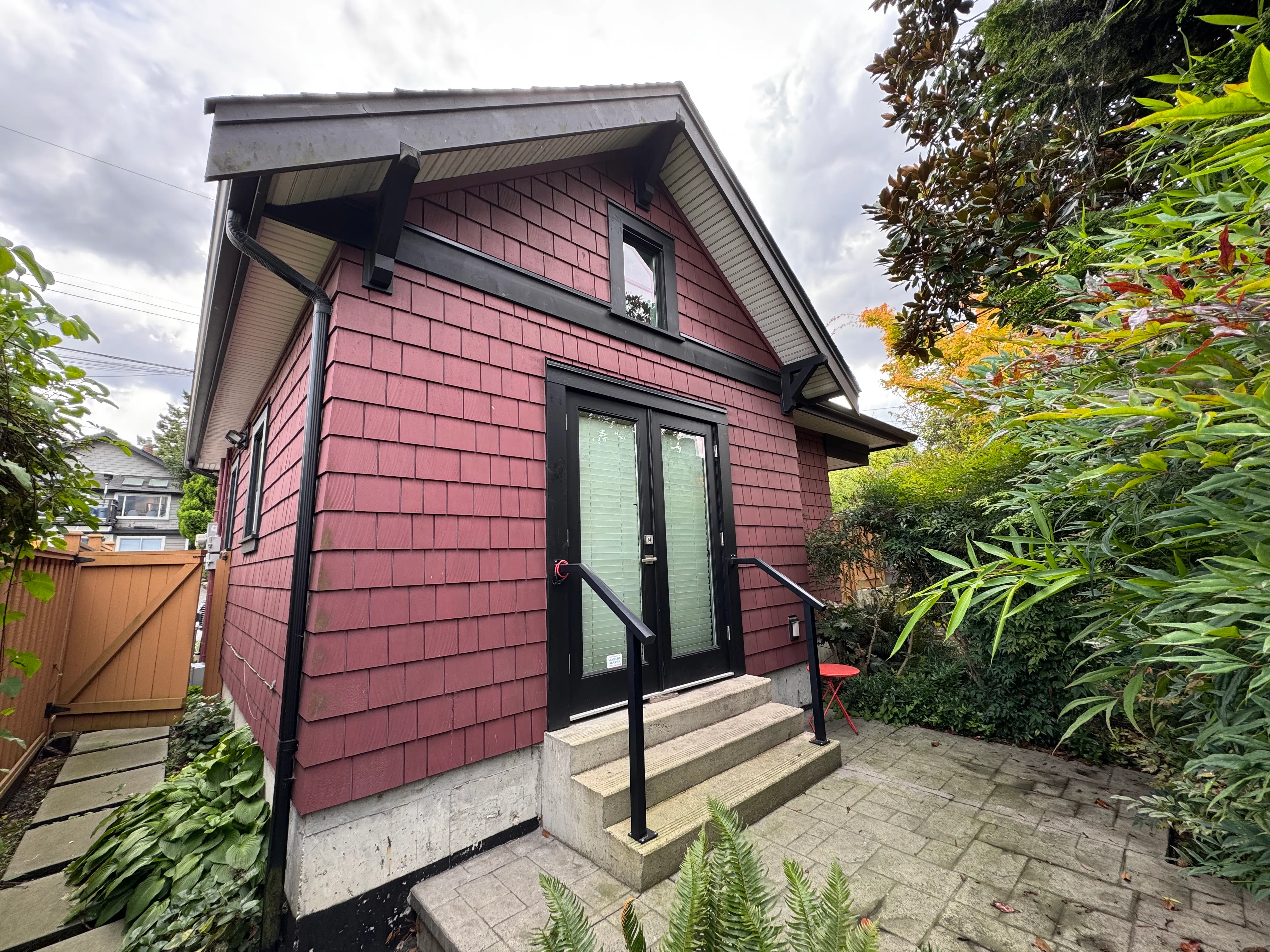 The cottage’s garden entrance — red cedar shingles and french doors